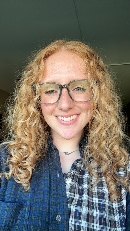 Selfie of Rachel wearing a plaid shirt and glasses